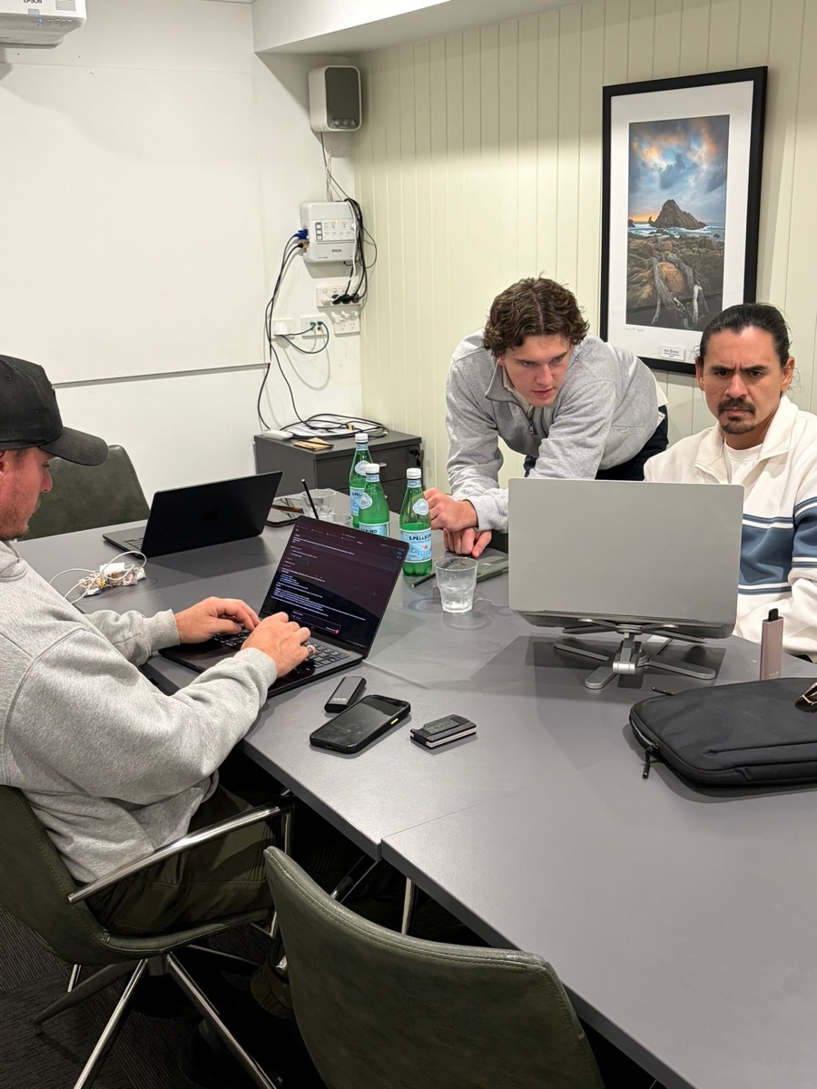 Three attendees mid-build at The Forge